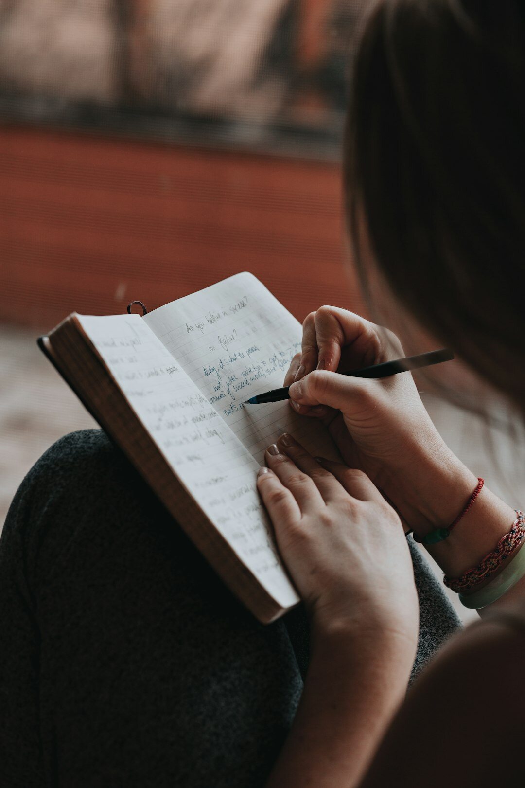 person writing goals in journal