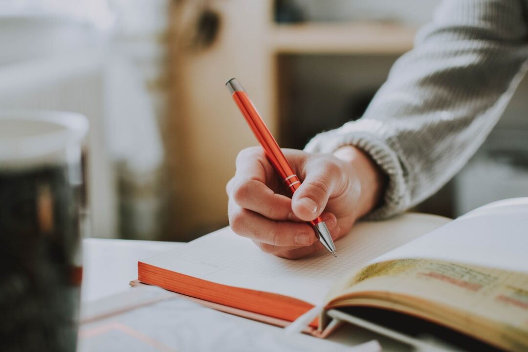 person writing in journal