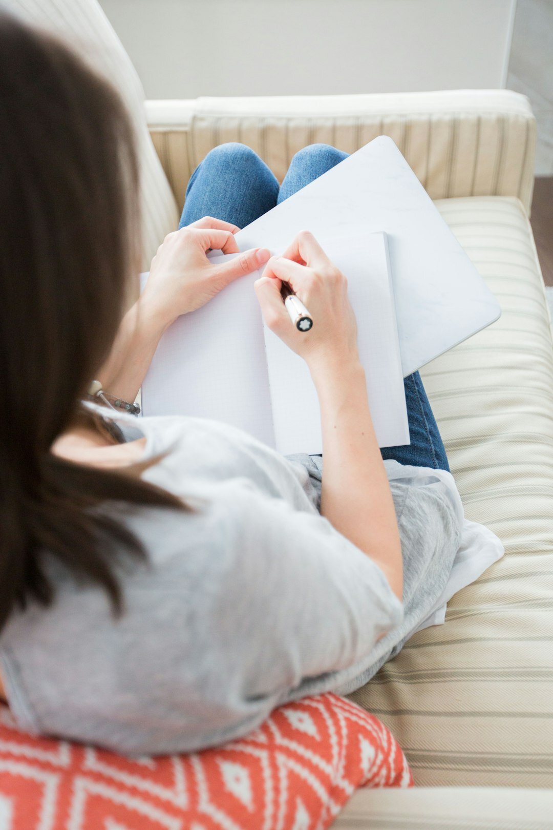 person writing in journal