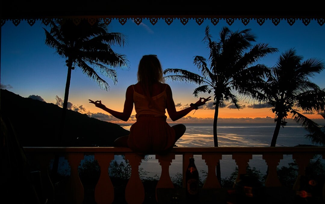 woman meditating at sunrise